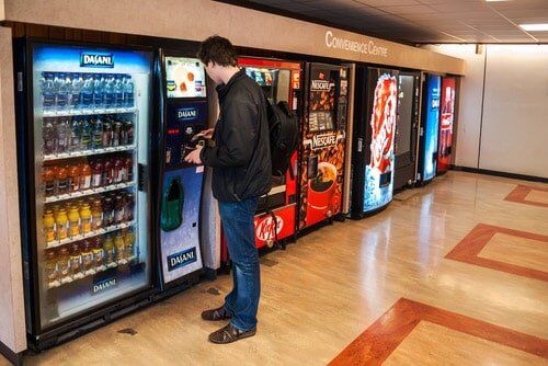 Men Buying from Vending Machine — Vending in Berrimah, NT