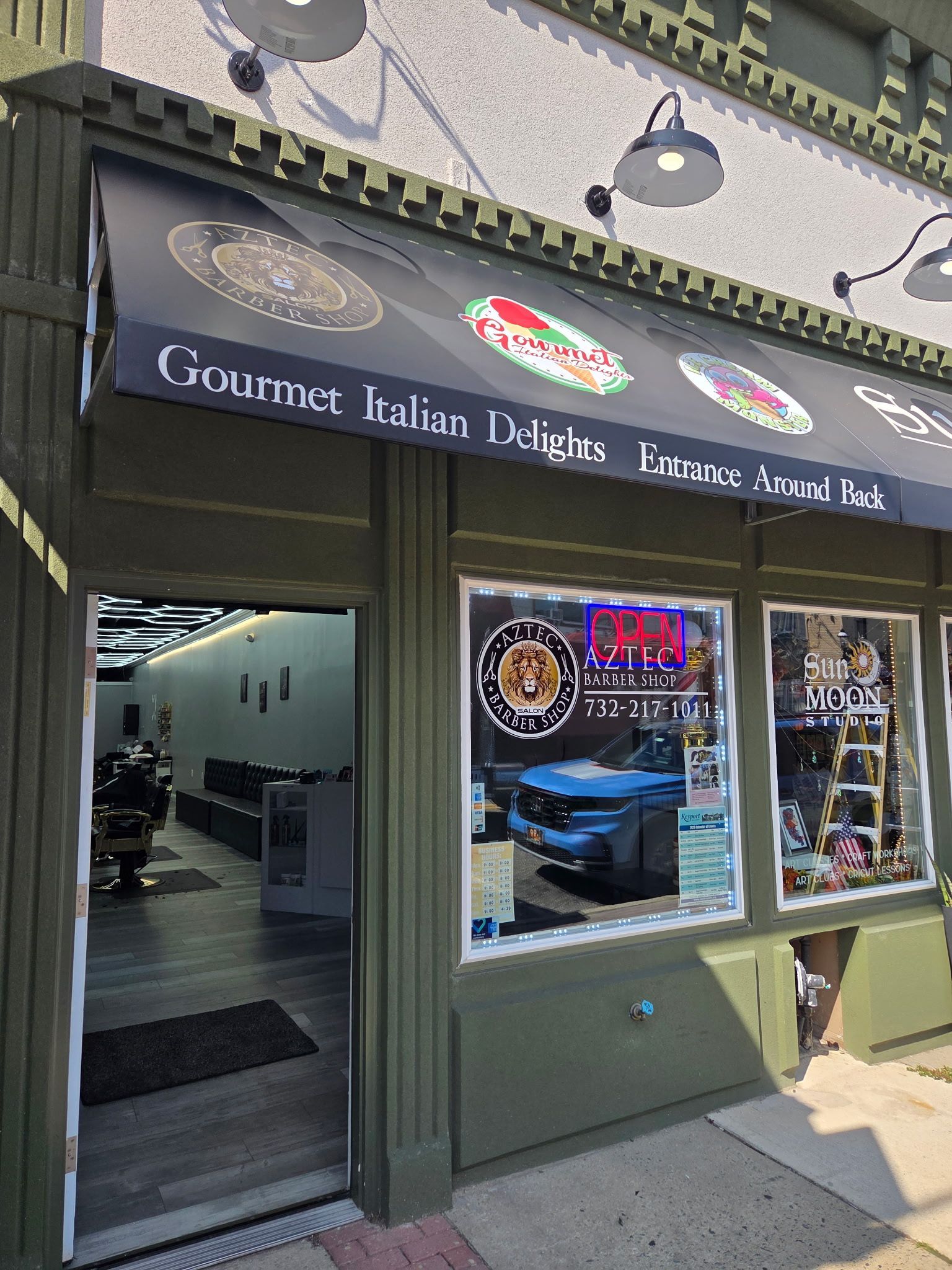 Exterior of an Italian deli with a black awning and 