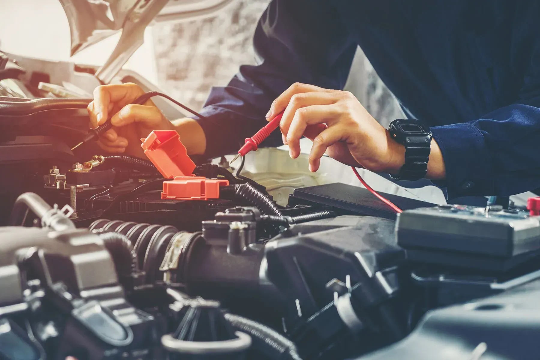 Mechanic Using Multimeter to Test Car Engine Wires — B Wild Auto Repairs In North Gosford, NSW