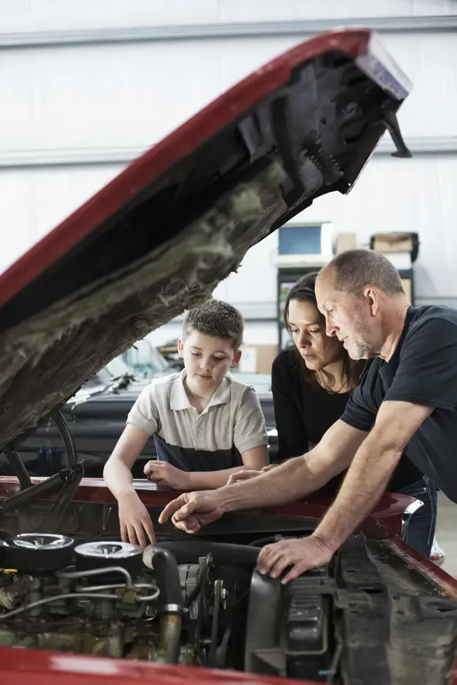 Family Looking at a Car Engine in a Garage — B Wild Auto Repairs In North Gosford, NSW