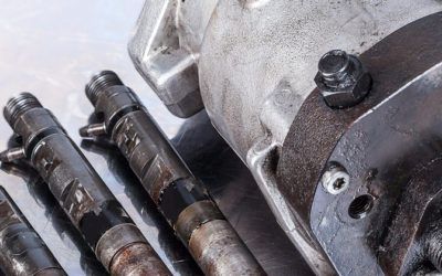 A group of fuel injectors are sitting next to each other on a table.