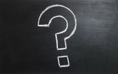 A question mark is drawn on a blackboard with chalk.