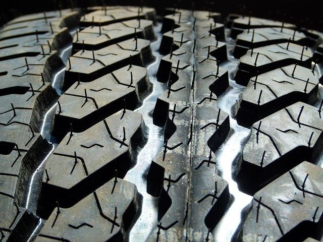 A close up of a tire with a few holes in it