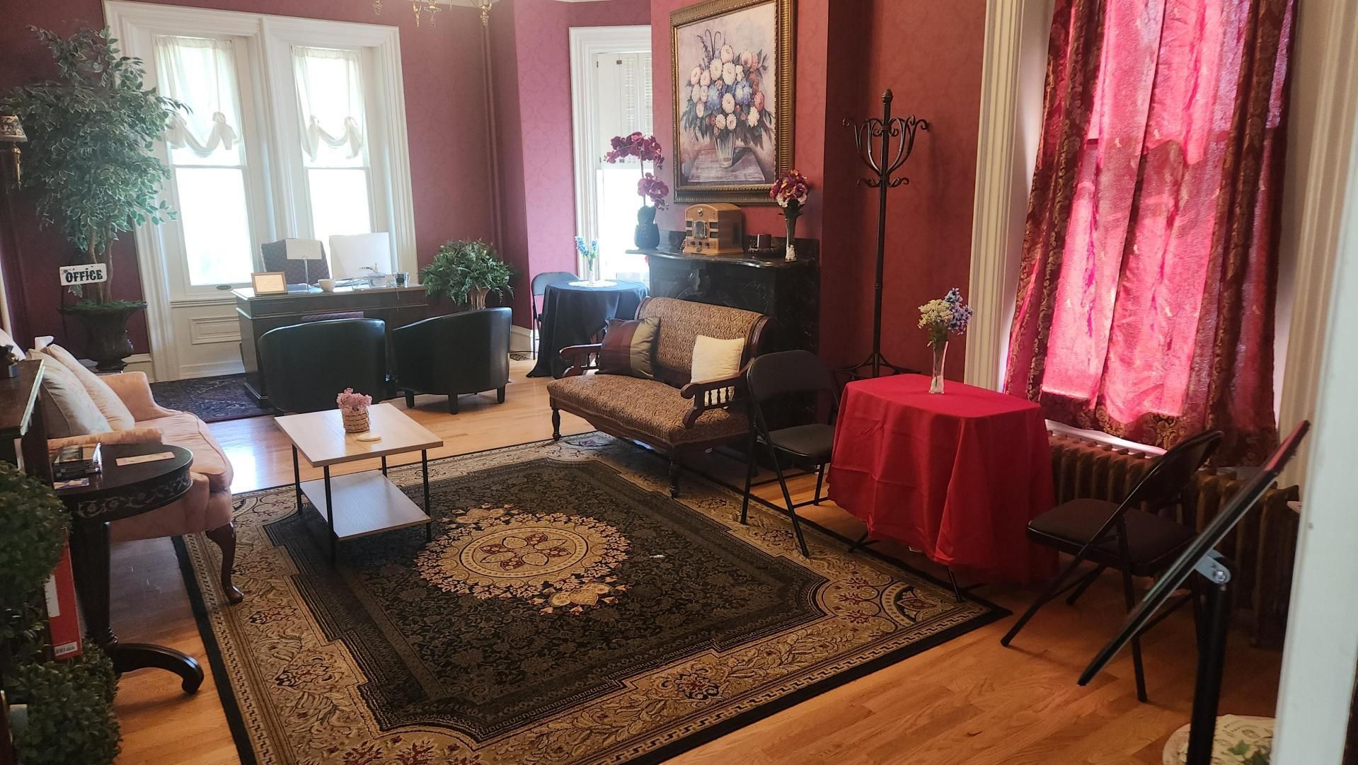 A living room with a rug , couch , table and chairs