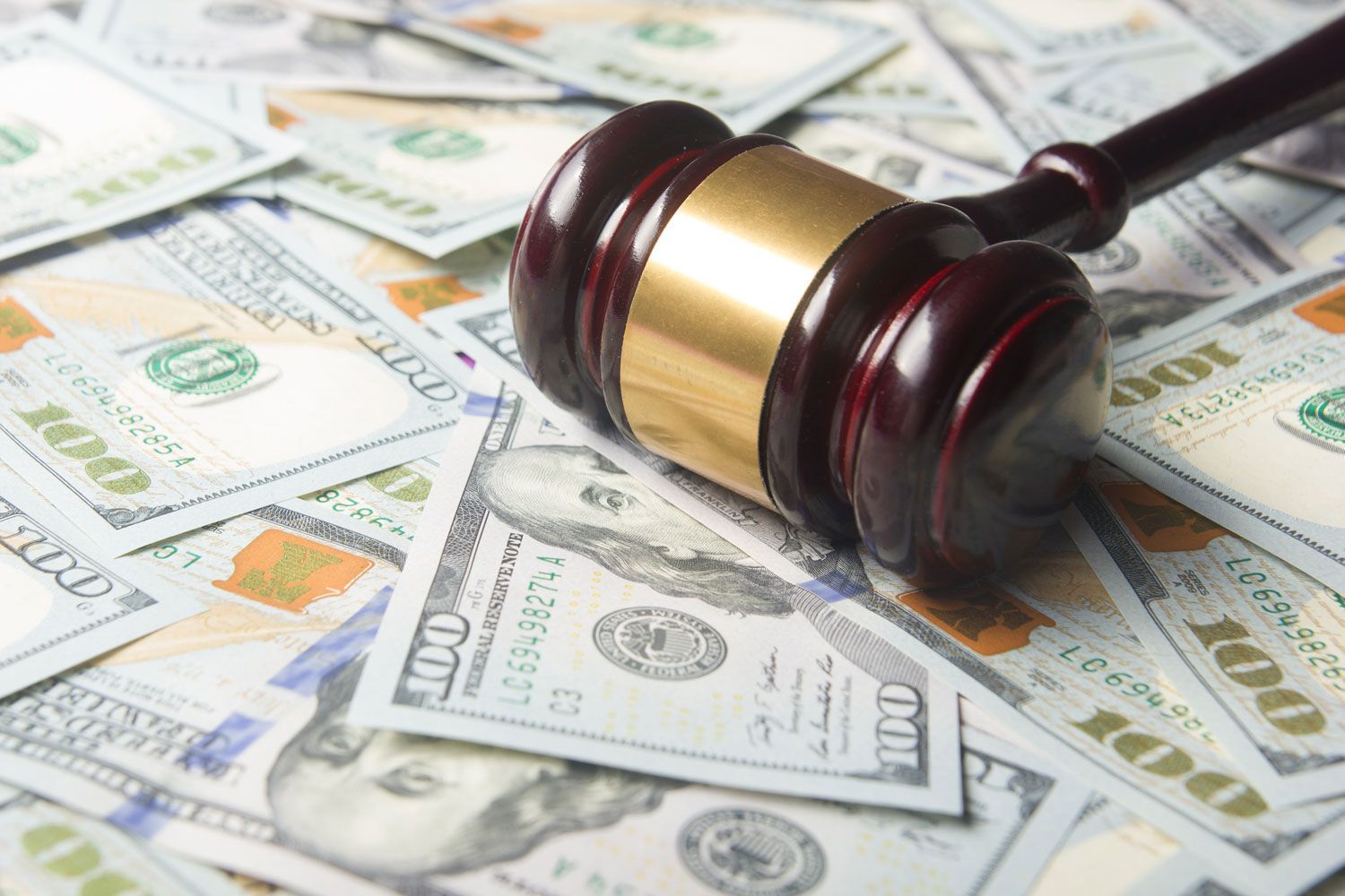 Gavel on dollars cash bills background