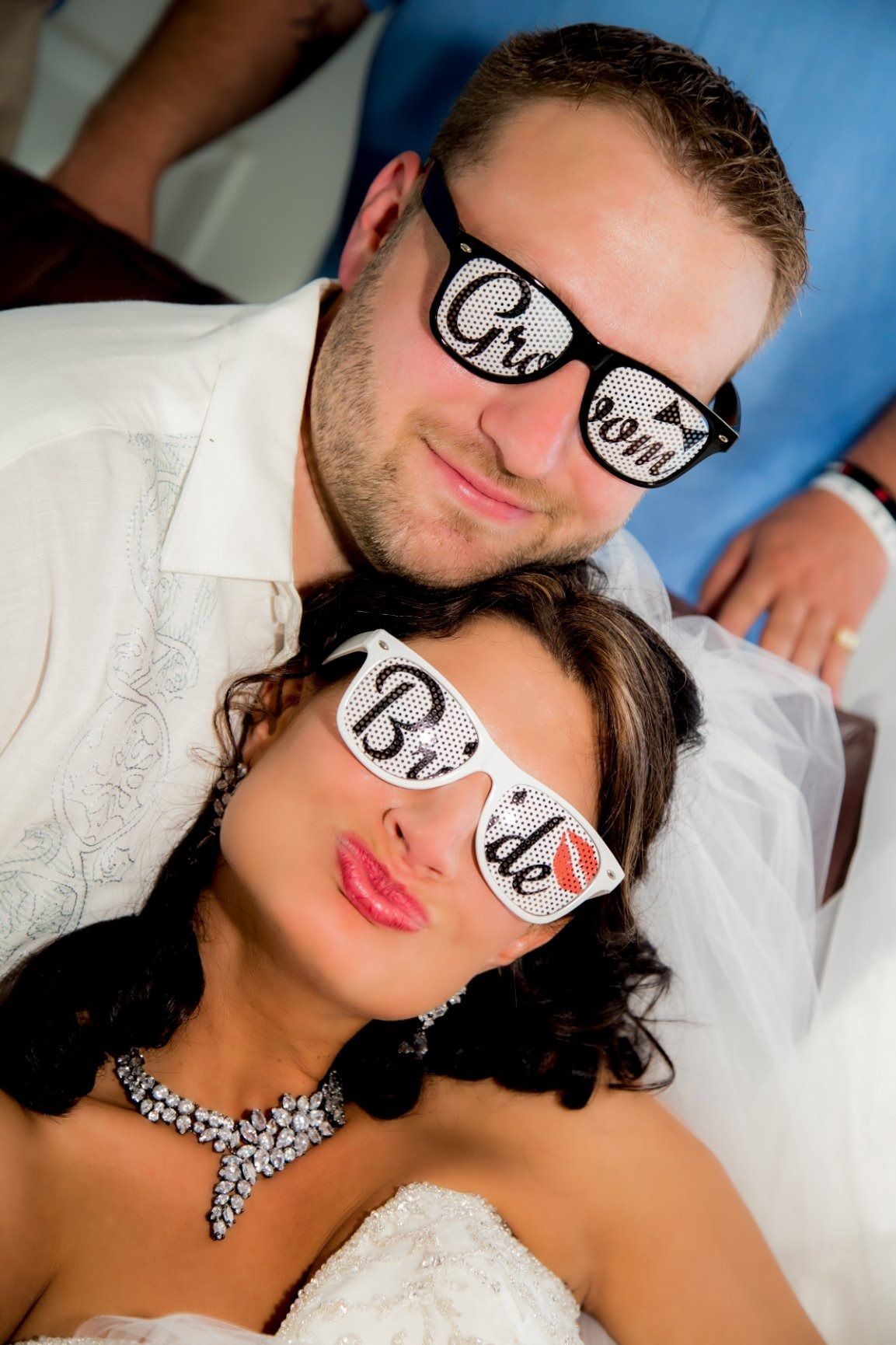 Bride and groom wearing novelty glasses with 
