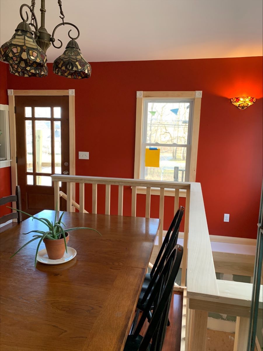 A dining room table with a potted plant on it