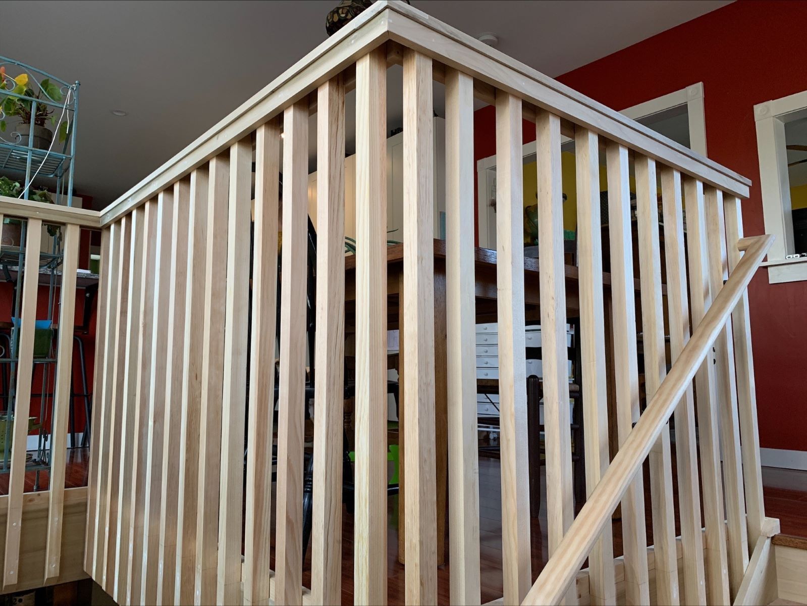 A wooden railing on a set of stairs in a house