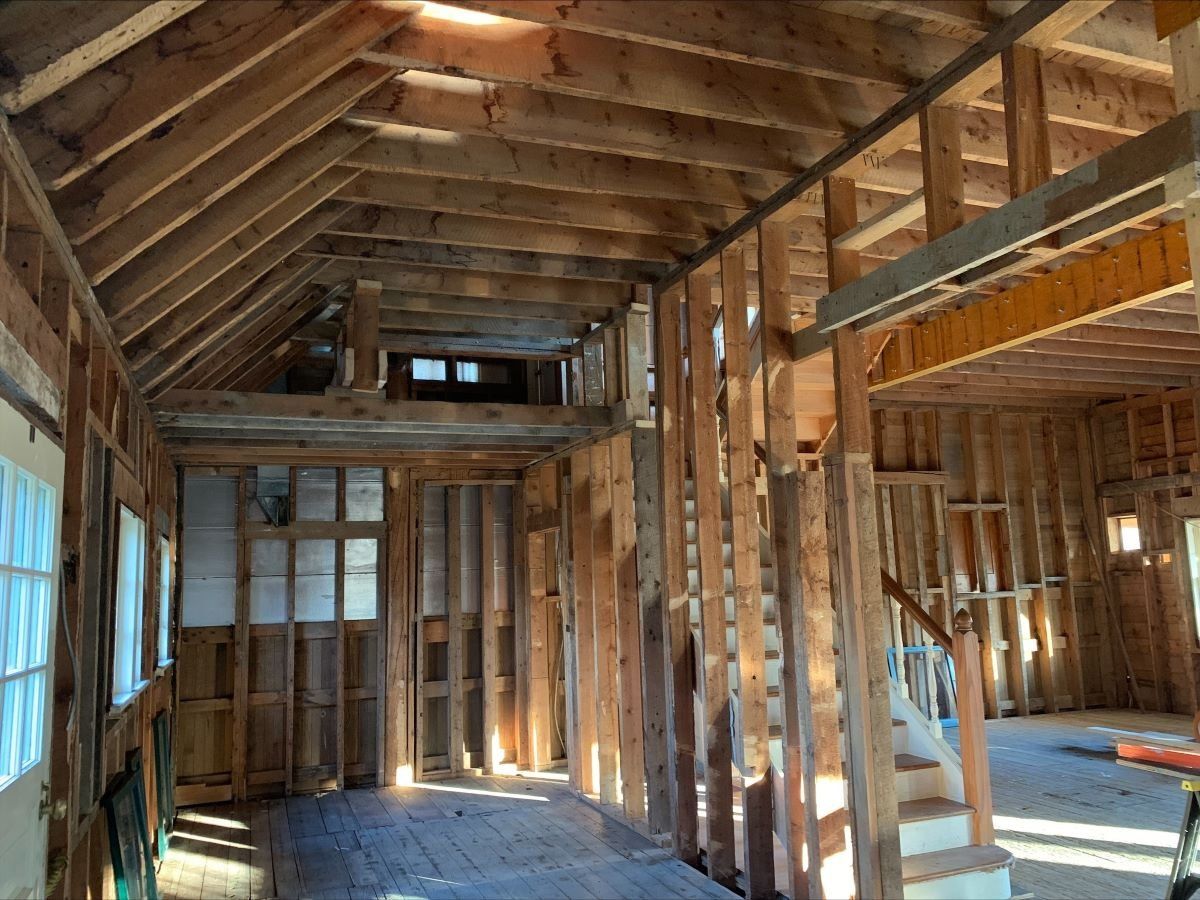 A house is being built with wooden beams and stairs.