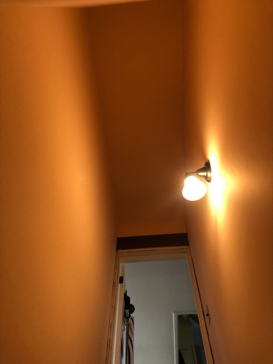 There is a light on the wall in the hallway.
