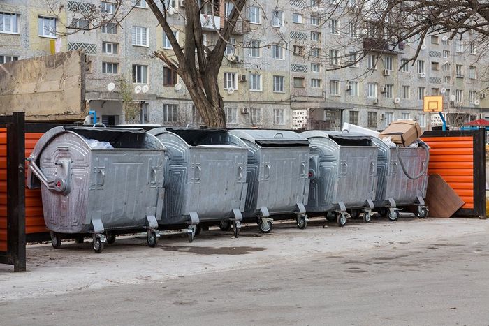 lined up garbage dumpsters
