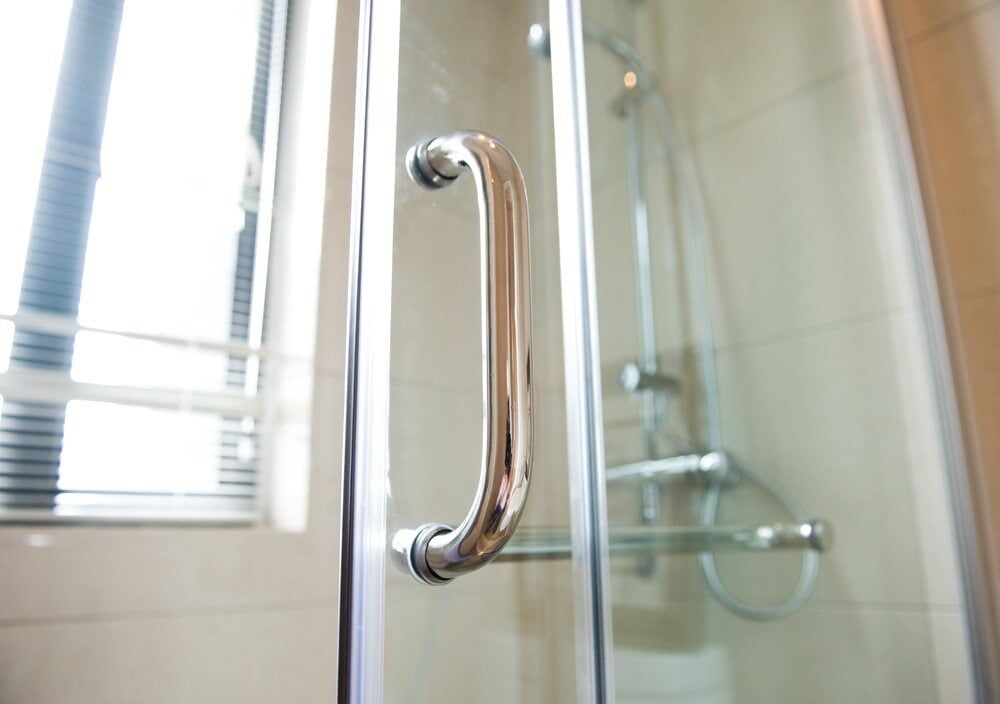 A Close up Of a Shower Door with A Handle in A Bathroom — Colour Splash in Port Stephens, NSW