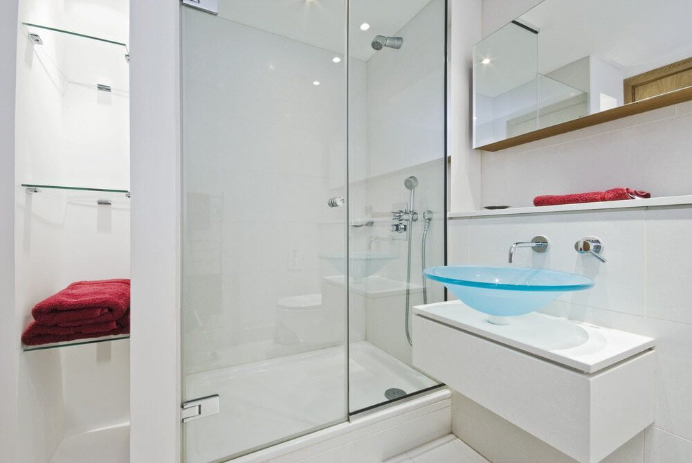 A Bathroom with A Glass Shower Door and A Sink — Colour Splash in Cessnock, NSW