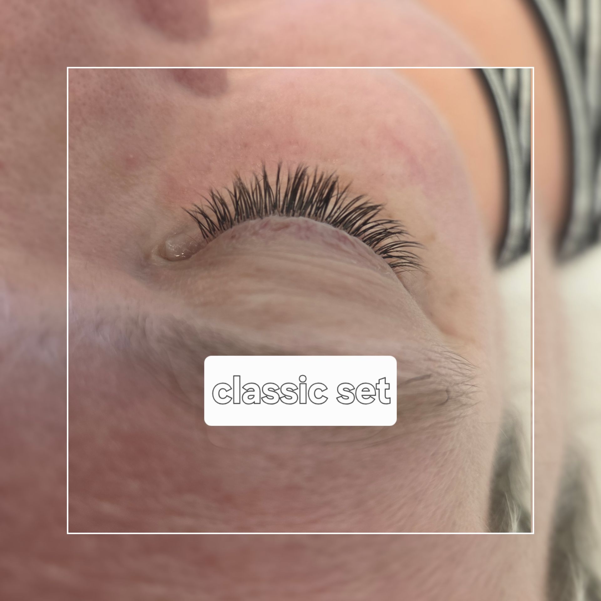 Close-up of an eye with classic eyelash extensions and a white label reading “classic set”
