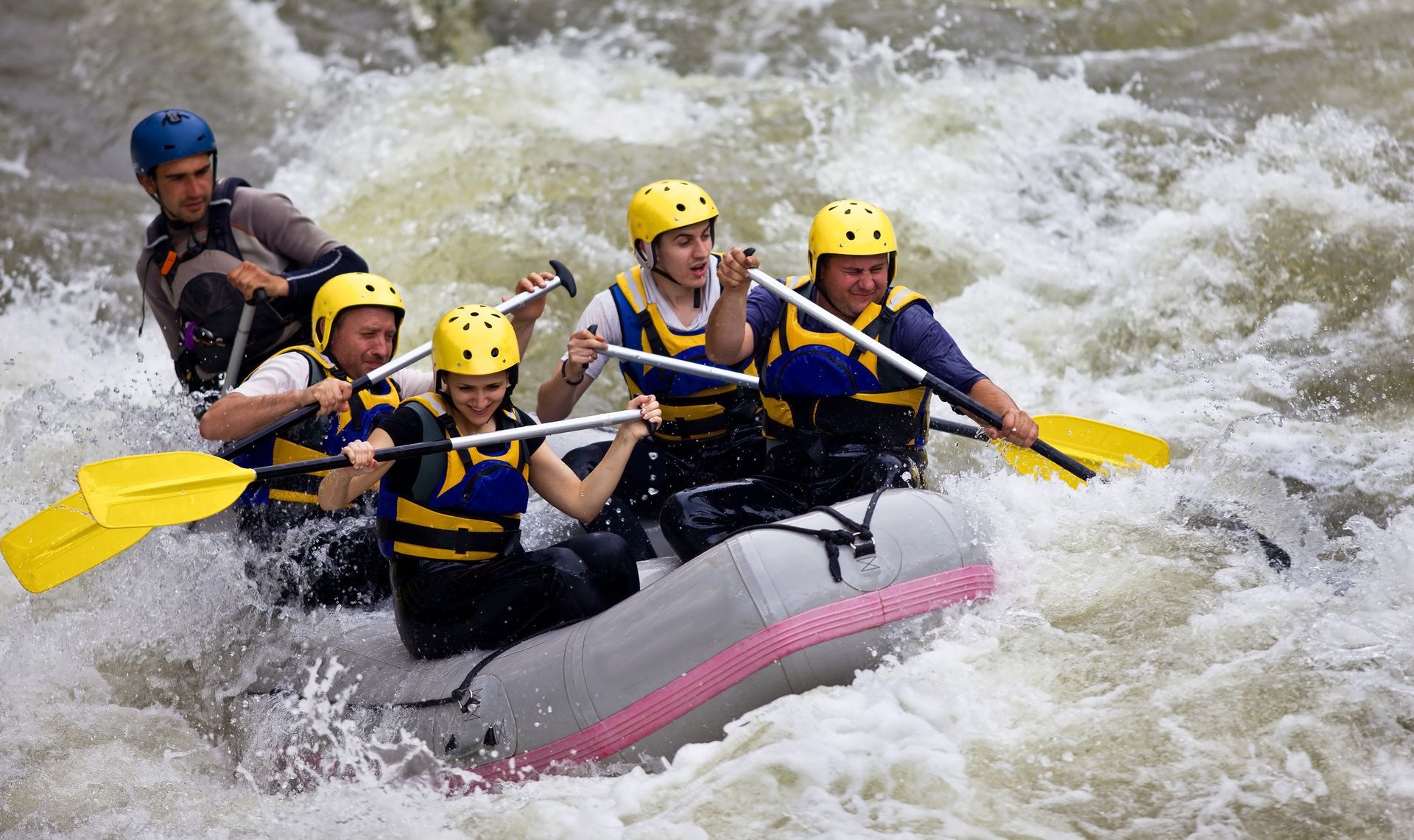 A group of people are rafting down a river in a raft.