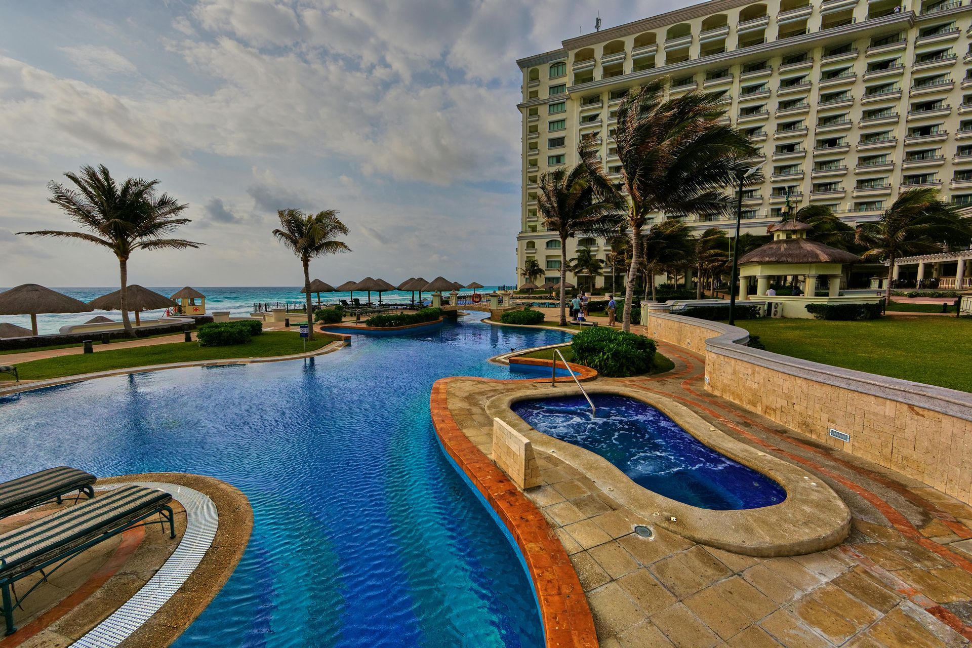 A large swimming pool with a large building in the background