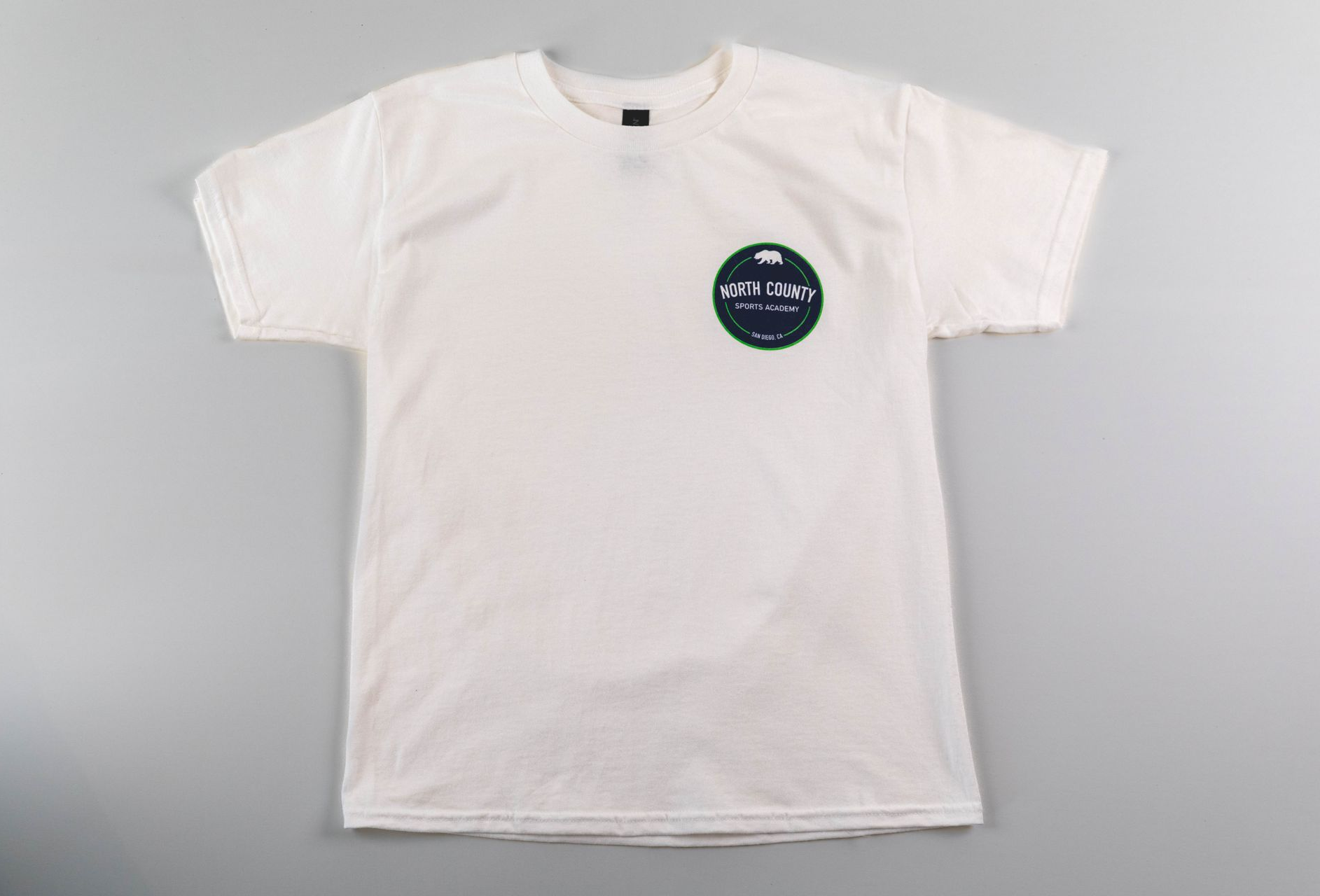 White T-shirt laid flat with a small circular logo on the chest