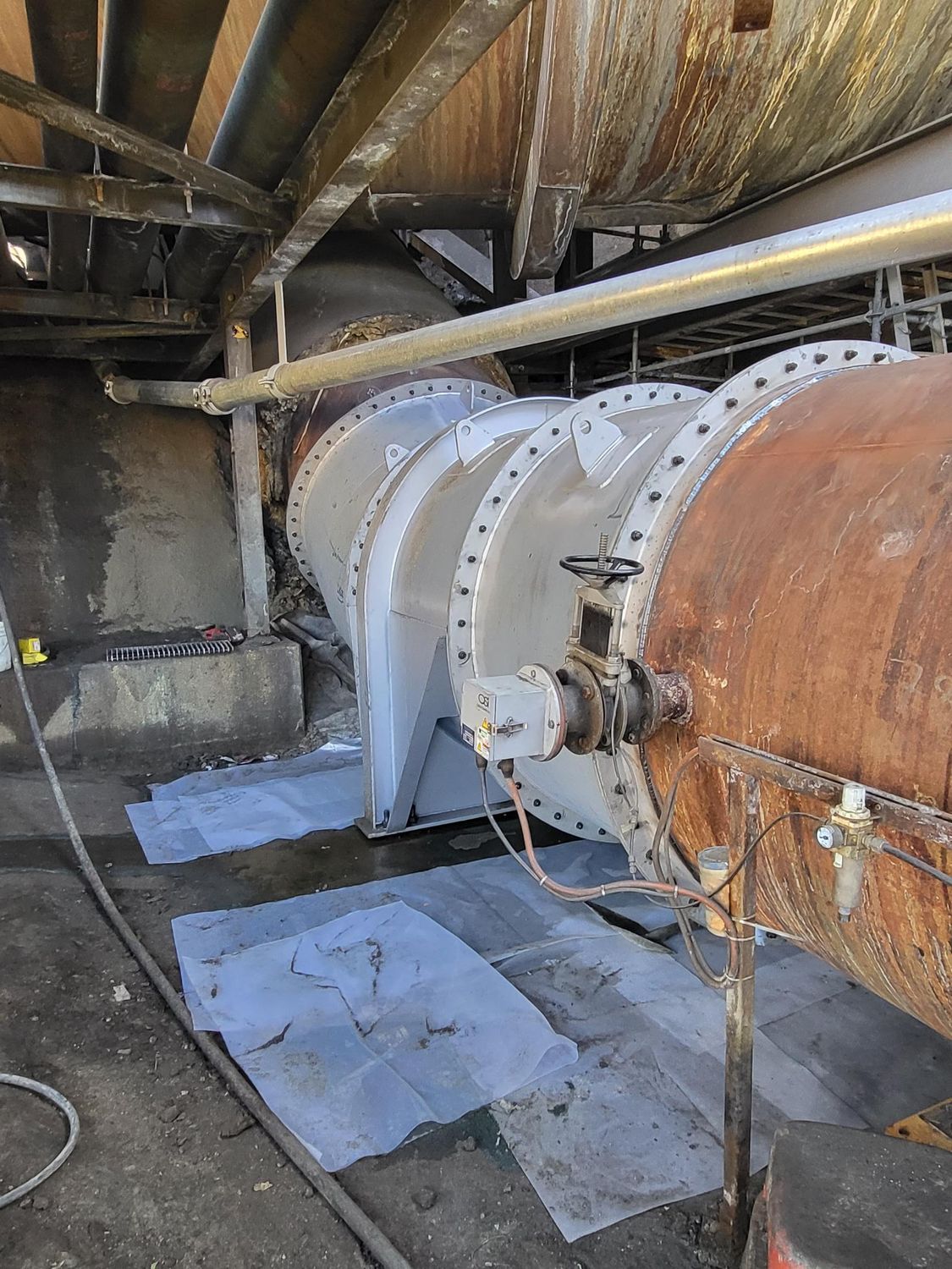 A Large Pipe Is Sitting On The Ground In A Factory — Custom Steel Fab in Garbutt, QLD
