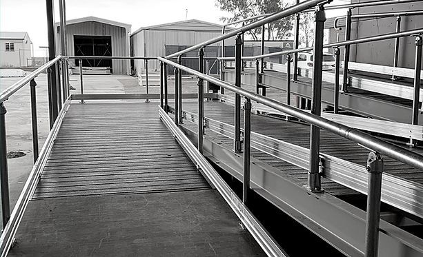 A Black and White Photo of A Ramp with A Railing — Custom Steel Fab in Garbutt, QLD