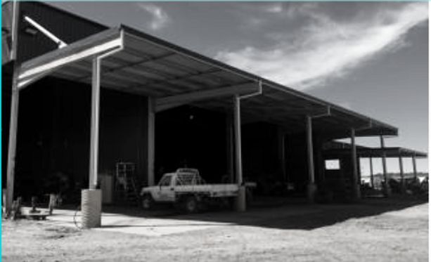A Truck Is Parked Under a Canopy in Front of A Building — Custom Steel Fab in Garbutt, QLD
