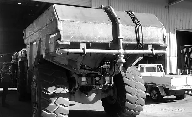 A Black and White Photo of A Dump Truck in A Garage — Custom Steel Fab in Garbutt, QLD