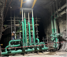 Industrial Machinery Room With Green Pipes, Valves, and Scaffolding in a Dark Utility Space — Custom Steel Fab in Bohle, QLD