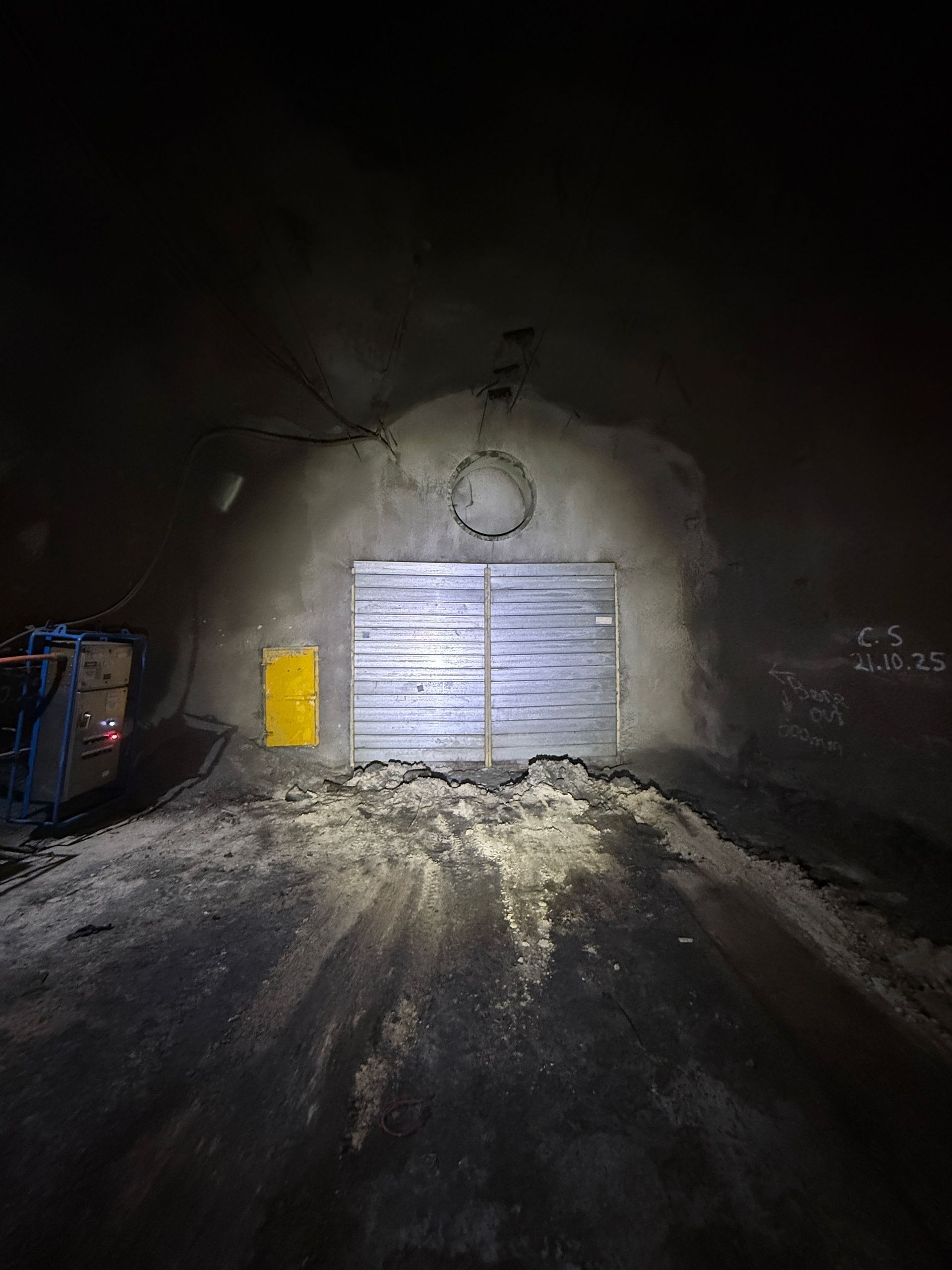 Snowy road at night leading to a closed metal gate set in a concrete arch, lit by headlights — Custom Steel Fab in Garbutt, QLD