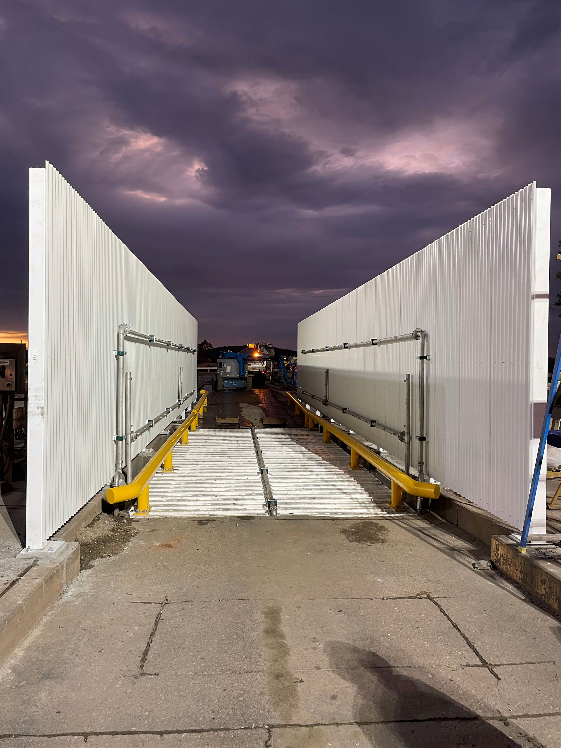Snow-dusted Bridge Deck Between White Barriers Under a Purple Sky at Dusk — Custom Steel Fab in Bohle, QLD
