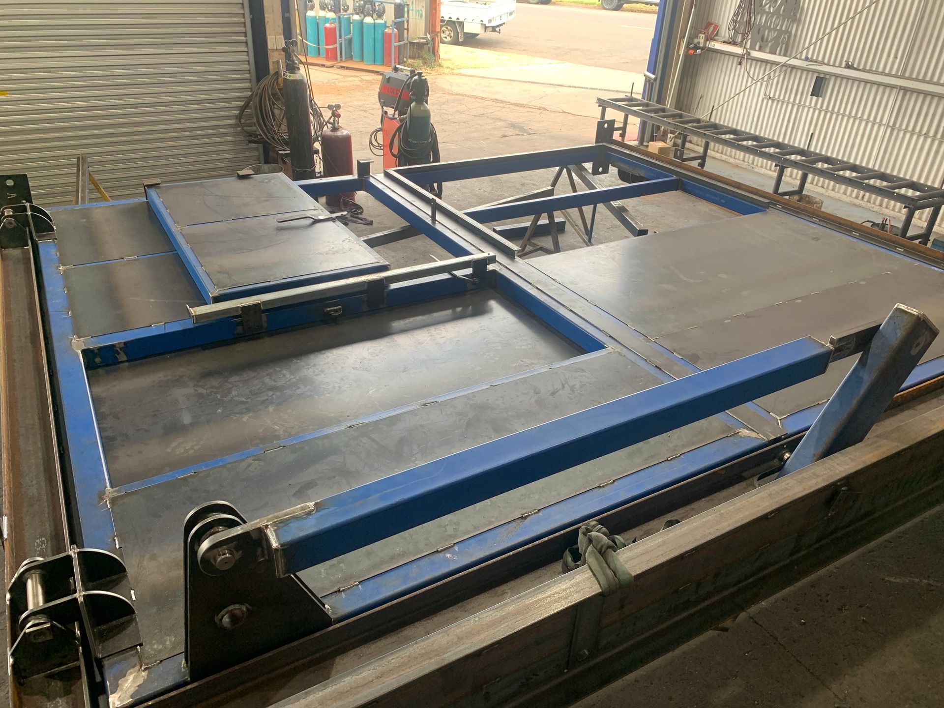 A Metal Structure Is Sitting On Top Of A Concrete Floor In A Garage — Custom Steel Fab in Garbutt, QLD