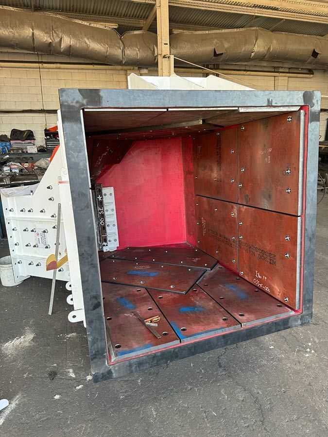 Open Metal Shipping Container With Red Interior and Rusted Floor in a Warehouse Garage — Custom Steel Fab in Bohle, QLD