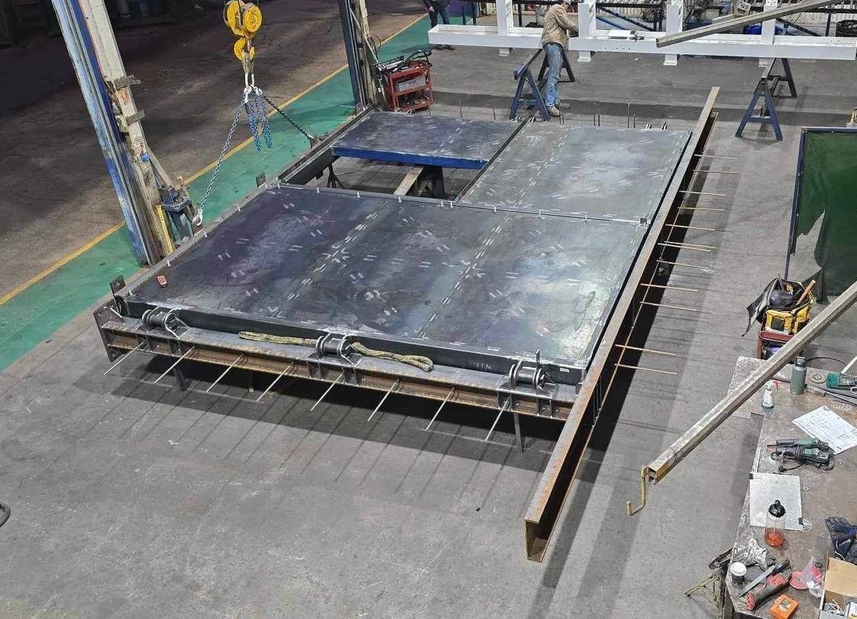 A Large Piece Of Metal Is Being Built In A Factory — Custom Steel Fab in Garbutt, QLD