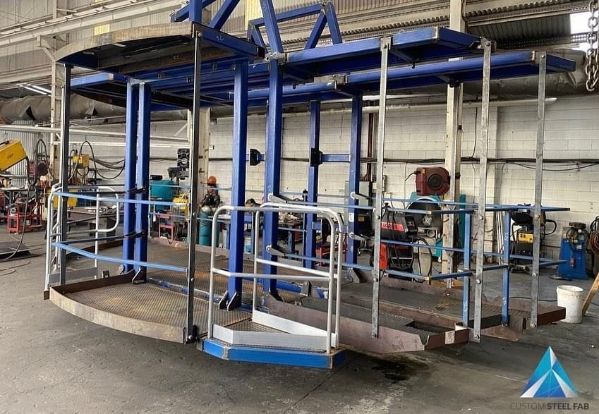A Large Blue Metal Structure Is Sitting In A Warehouse — Custom Steel Fab in Garbutt, QLD