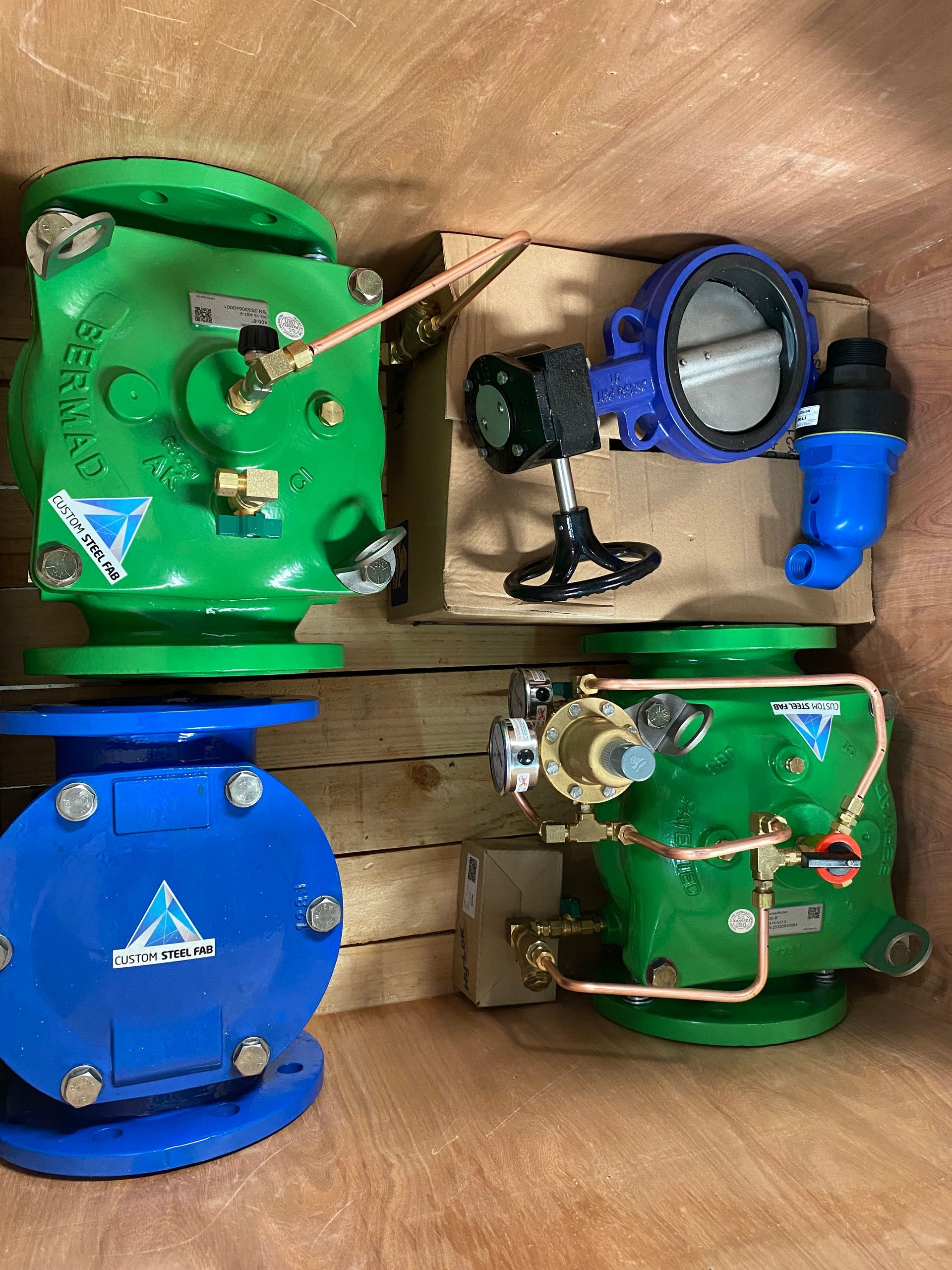 Four Colorful Industrial Mechanical Devices in a Box, Mostly Green and Blue — Custom Steel Fab in Bohle, QLD