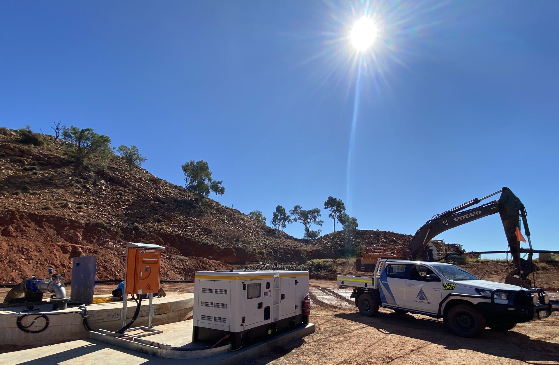 Construction Site With Excavator, White Truck, Generator, and Workers — Custom Steel Fab in Bohle, QLD