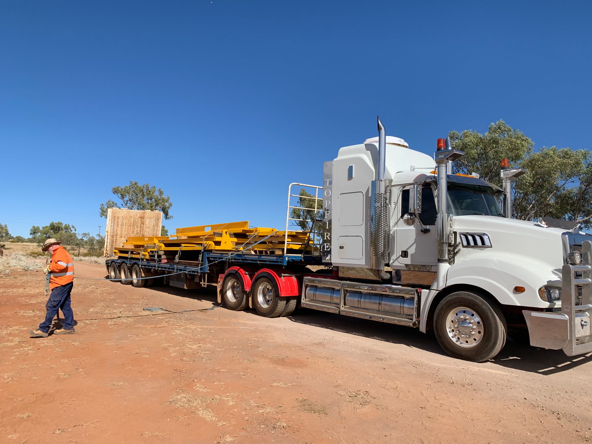 A Large White Semi Truck Is Parked In A Dirt Field — Custom Steel Fab in Garbutt, QLD