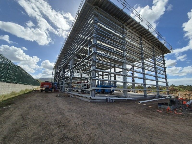 Large Steel-framed Building Under Construction Beside a Dirt Road — Custom Steel Fab in Bohle, QLD