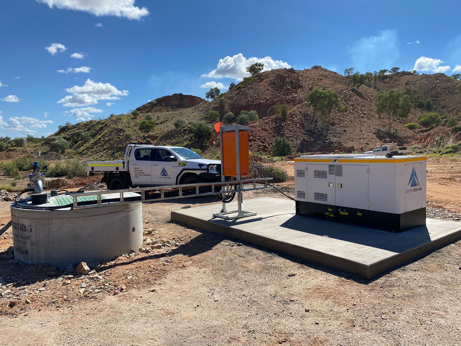 Construction Site With White Utility Truck, Orange Tank, and Generator on Dirt — Custom Steel Fab in Bohle, QLD