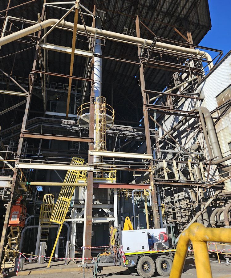 A Large Building With A Lot Of Pipes And Stairs — Custom Steel Fab in Garbutt, QLD