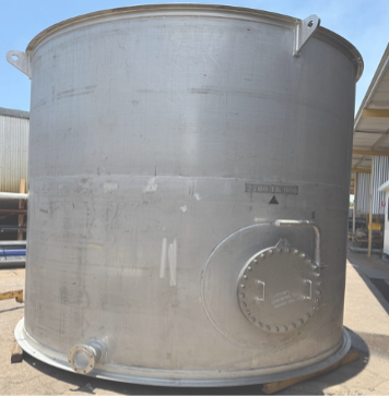 Large Gray Cylindrical Industrial Tank With a Bolted Access Hatch and Pipe Fittings Outdoors — Custom Steel Fab in Bohle, QLD