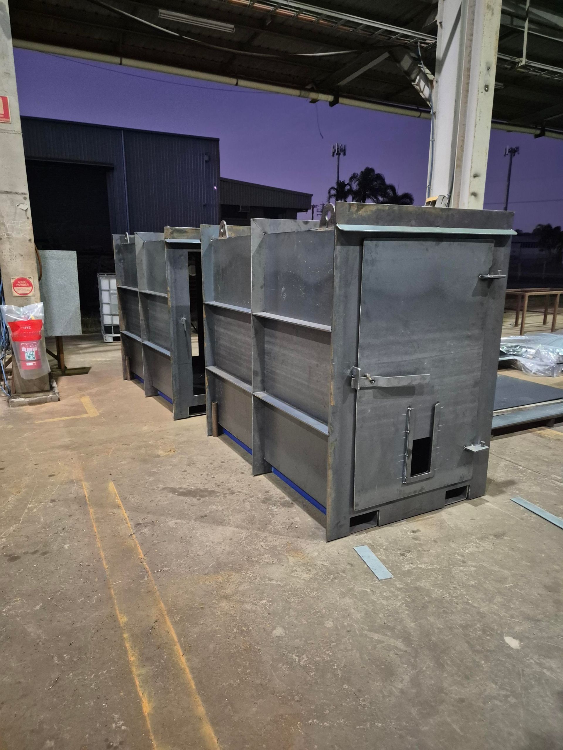 Large Black Metal Bins on a Warehouse — Custom Steel Fab in Bohle, QLD