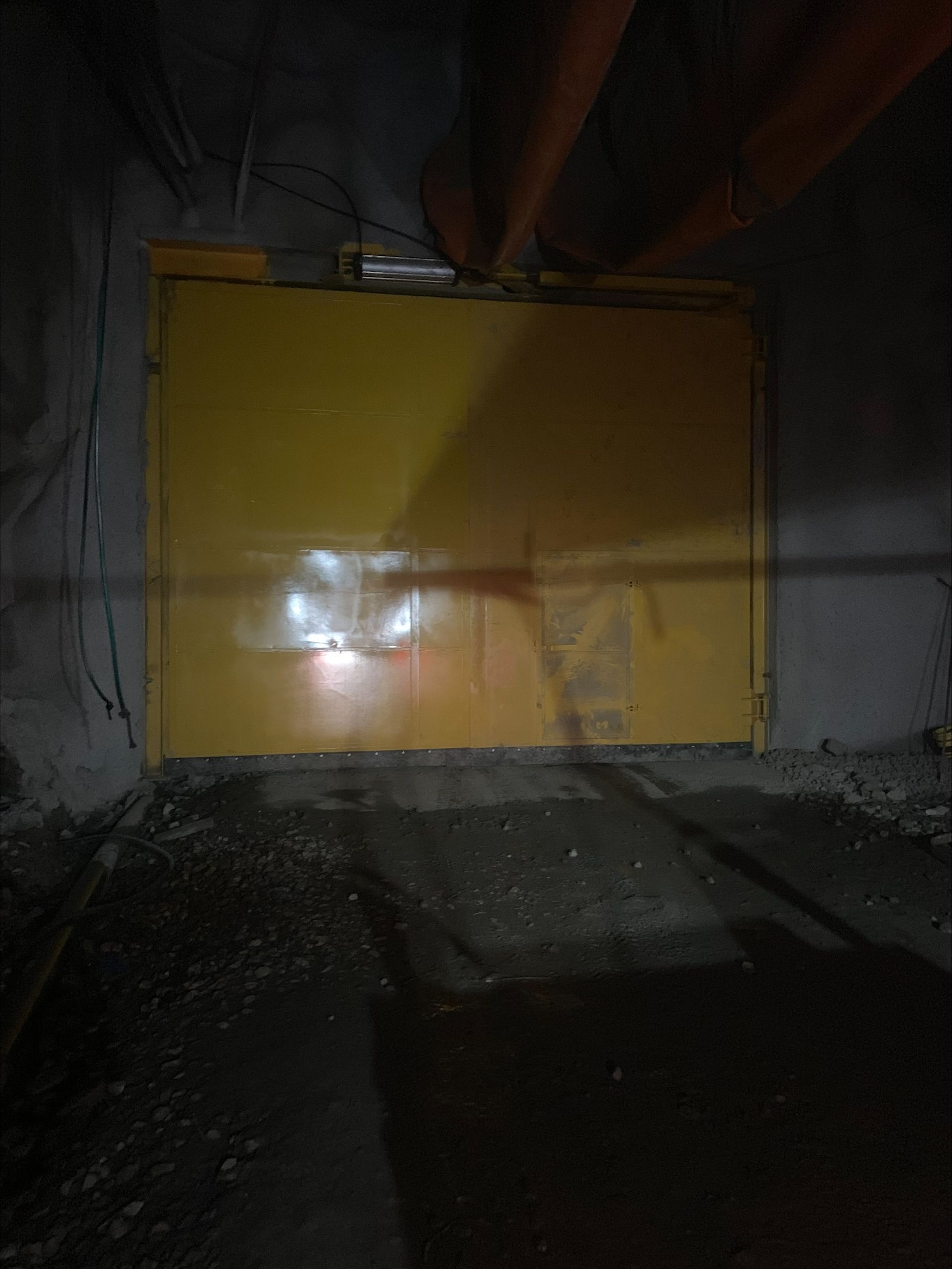Dark Industrial Hallway With a Yellow Metal Door and Exposed Orange Pipes — Custom Steel Fab in Bohle, QLD