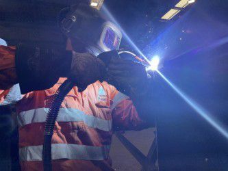 Person in Orange Reflective Jacket and Helmet With Face Shield — Custom Steel Fab in Bohle, QLD