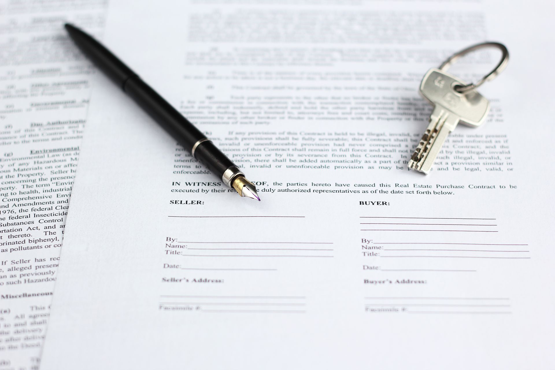 Legal document for sale of real estate, with a gold-nibbed fountain pen and house keys. Legal document for sale of real estate, with a gold-nibbed fountain pen and house keys.