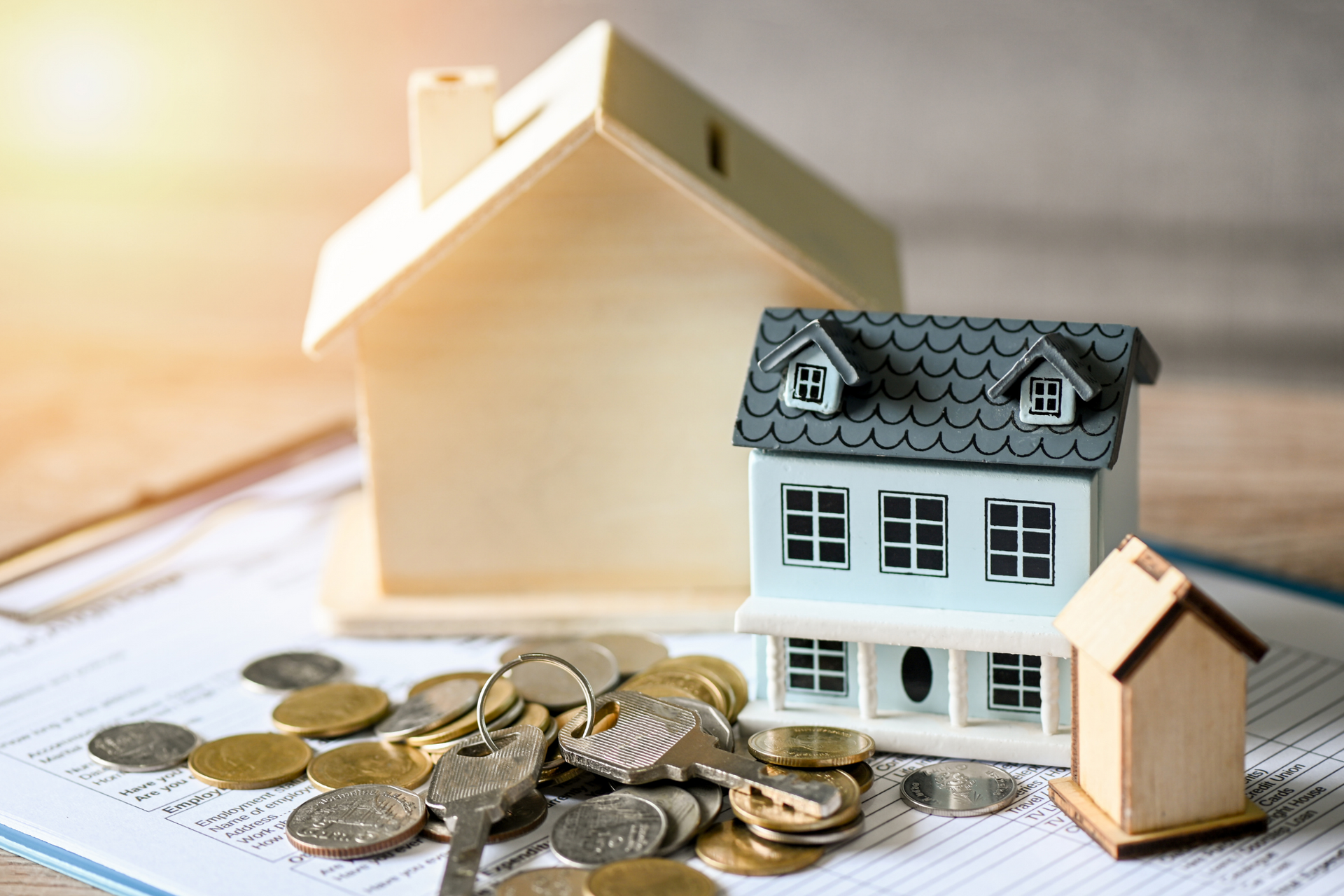 miniature house with coins