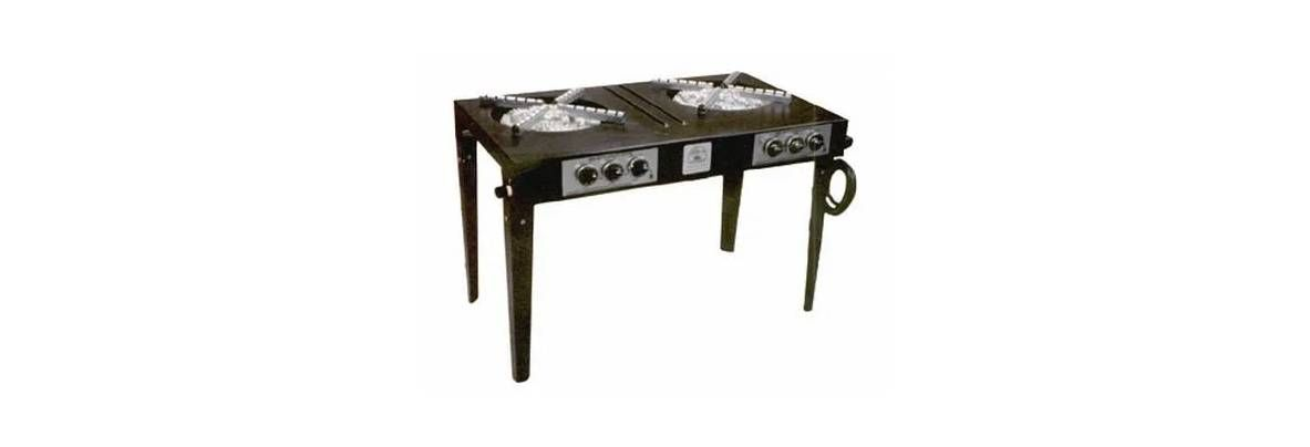 A black, two-burner portable outdoor stove with legs and a gas connection hose, isolated on a white background.