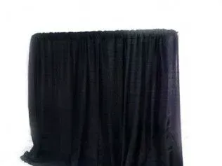A rectangular table covered with a solid black floor-length fabric drape against a plain white background.