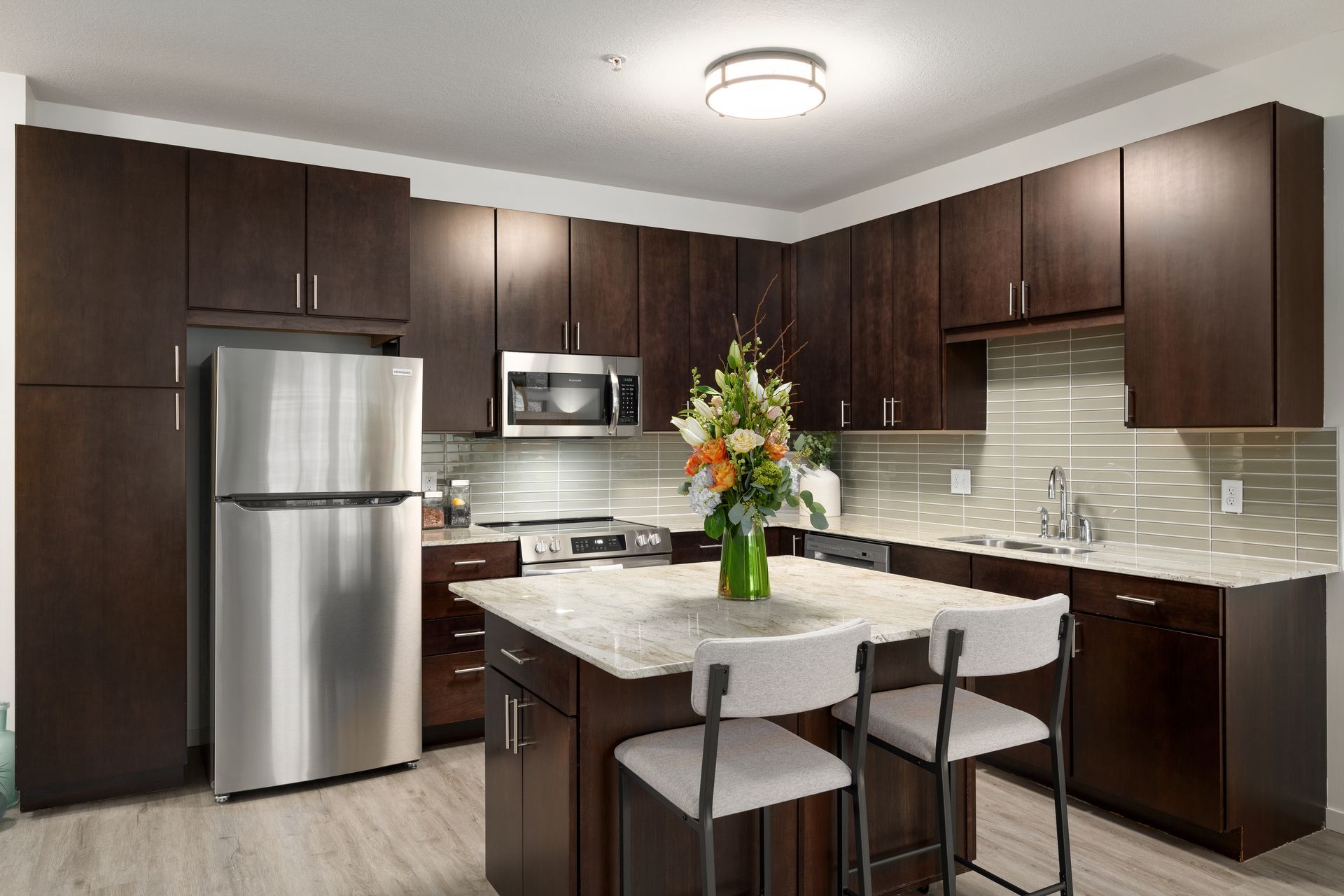 a kitchen with stainless steel appliances and wooden cabinets .