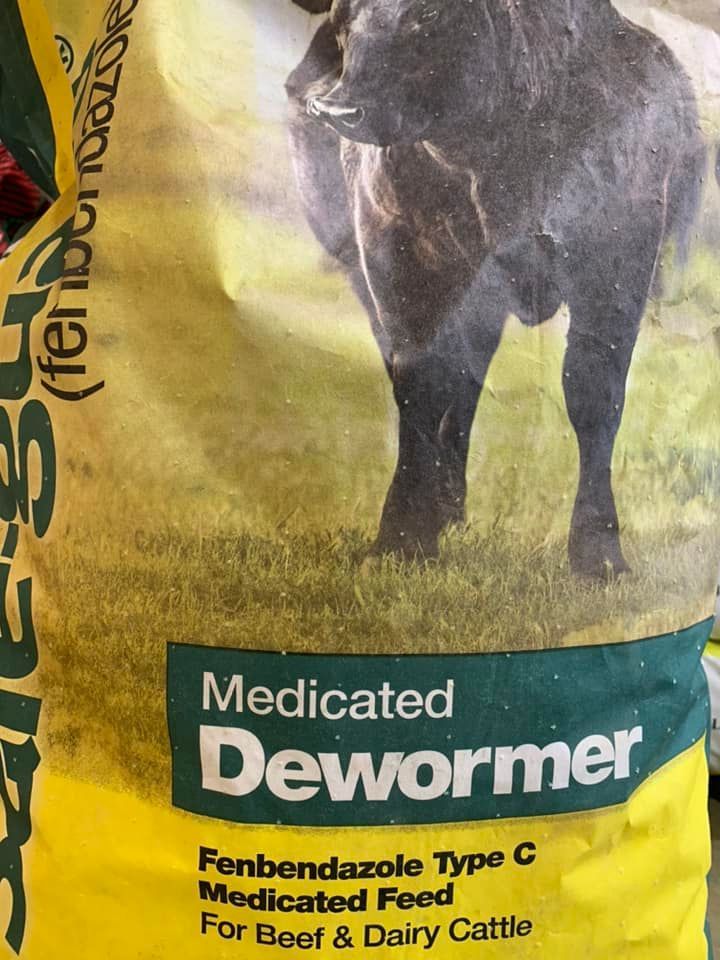 Yellow bag of Medicated Dewormer for beef cattle and dairy cattle, with a black cow graphic.