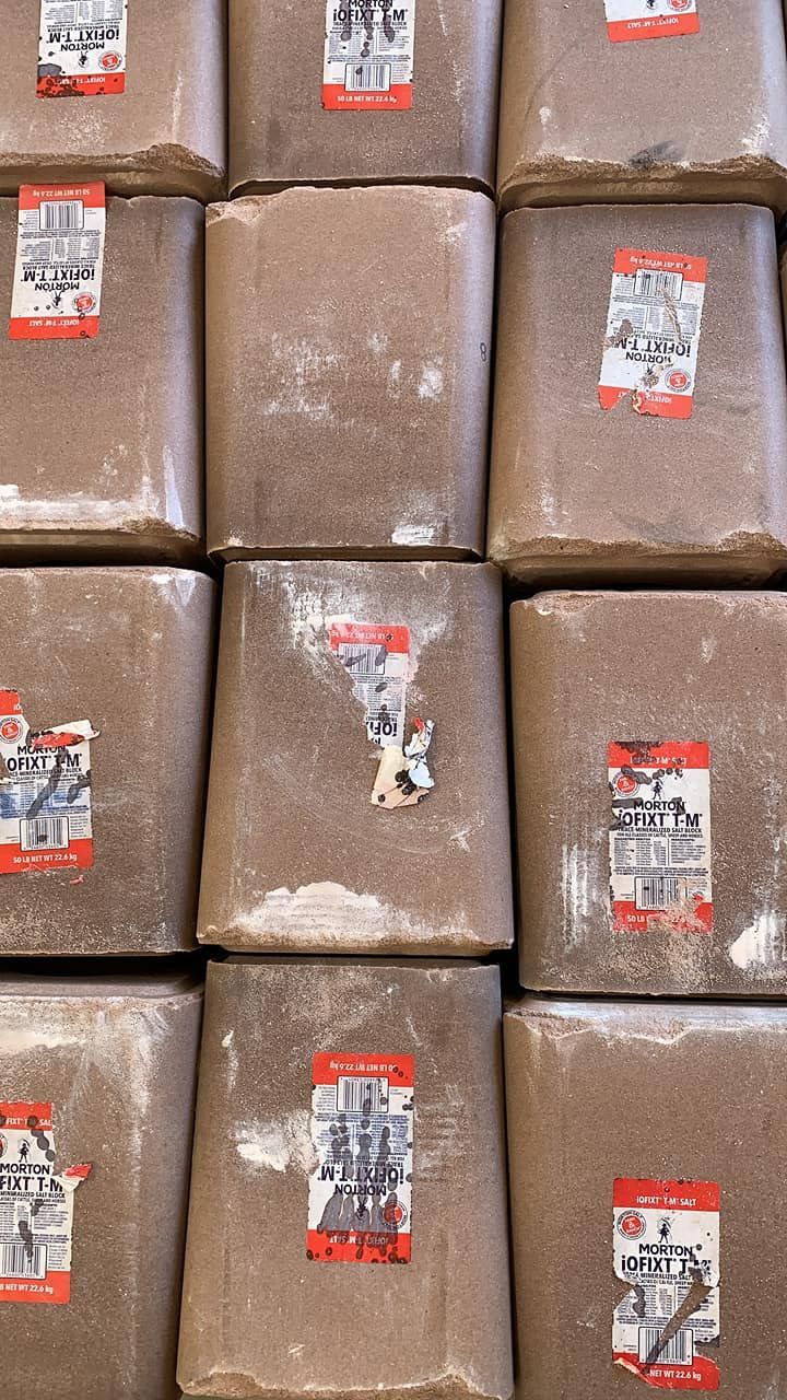 Stacked brown-wrapped packages with red labels, arranged in a tight grid.