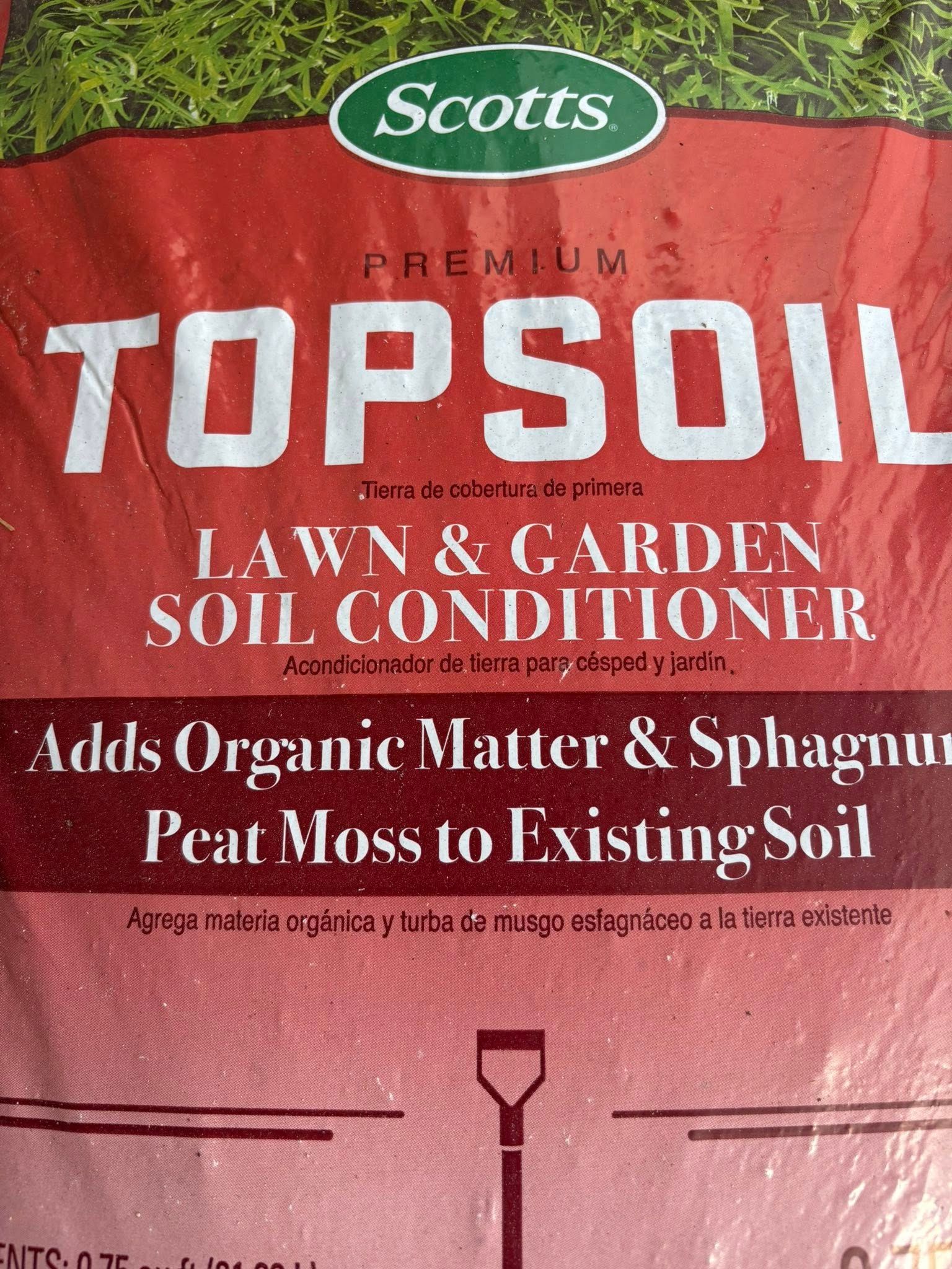 Scotts Premium Topsoil bag with red packaging and white text, lawn and garden soil conditioner